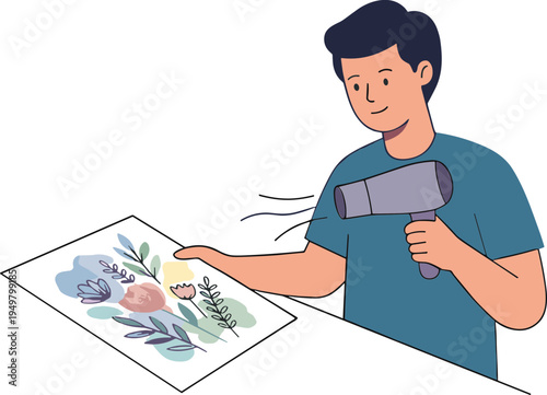 Man uses hairdryer on floral artwork on table indoors