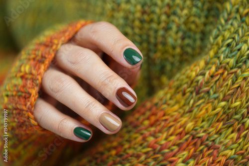 Womans hand with painted nails and colorful knitted sweater closeup transparent background