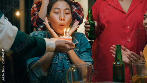 Photography Group of young adult Asia friend surprised with birthday cake and drinking alcohol beer and fun laugh enjoy hangout party in night life indoor home
