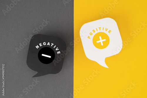 negative and positive text with minus and plus sign on real white and grey paper speech bubble on grunge paper background
