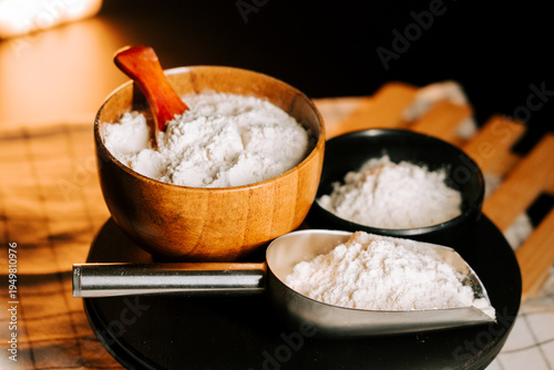Photos Flour surrounded by measuring tools on a kitchen counter with a soft glow in the