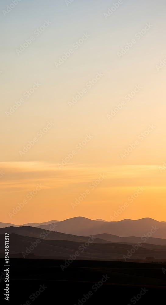 Fototapeta premium Golden Hour Light Over a Tranquil Mountain Vista.