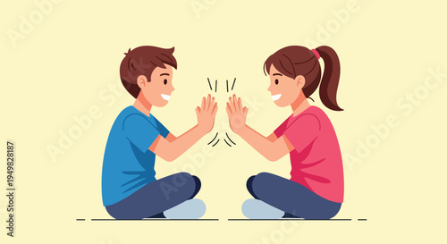 Two children smiling and giving each other a high five while sitting