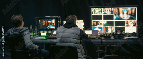 Professional Technical Crew Working in Broadcast Control Room with copy space
