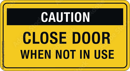 A close-up view of a yellow caution sign with a black stripe reading close door when not in use indoors.