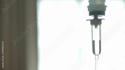 close up of a slow intravenous drip with a blurred blue background stand in expansion capsule Surgeons operate on a patient in the operating room
