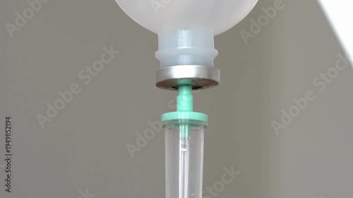 background Close-up of IV drip chamber dripping medication in slow motion 4K video Operating room IVIntravenous fluid dripping in drip chamber 4K UHD