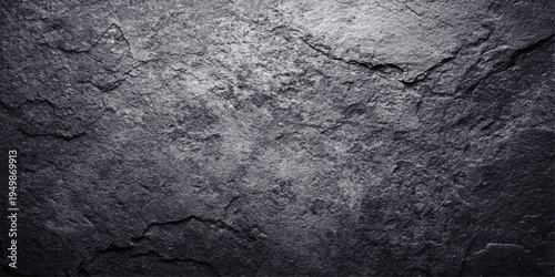 Aged black and white wood background featuring a cracked grunge stone texture with a rough gray cement pattern and macro marble detail