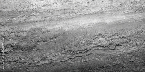 A black and white abstract landscape of natural stone and snow on the road where the winter texture meets a frozen river shore under a vast outdoor sky