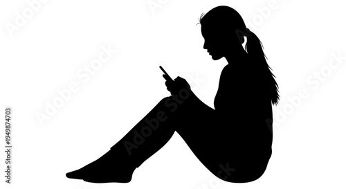 A silhouette of a woman sitting and using her smartphone