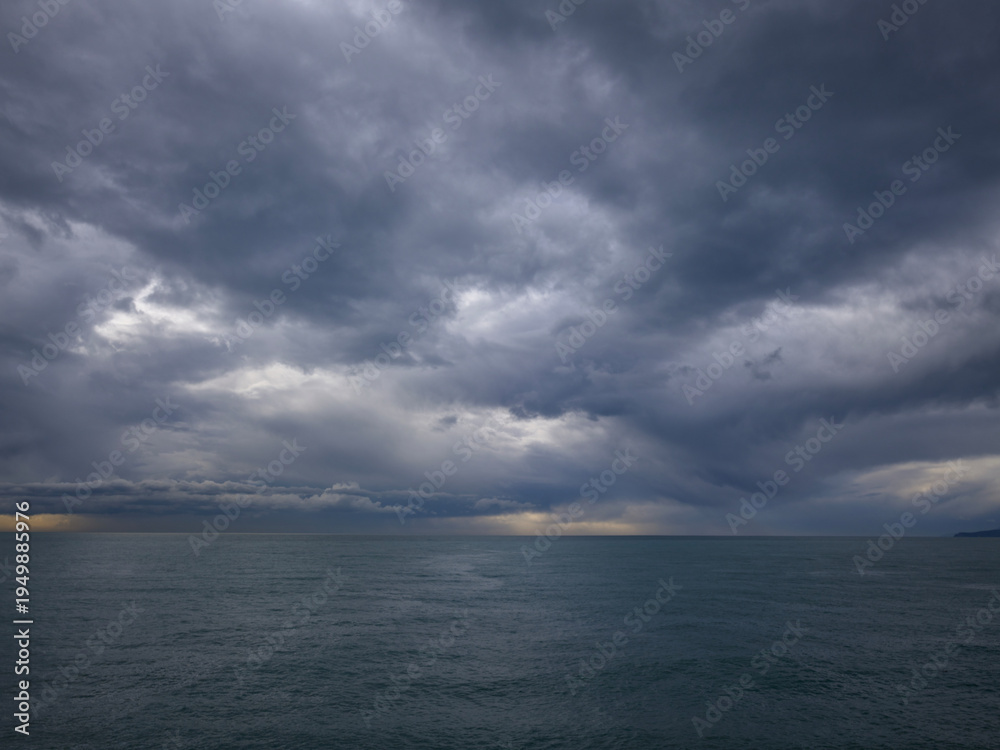 Fototapeta premium beautiful sandy shore with calm blue water on a cloudy day