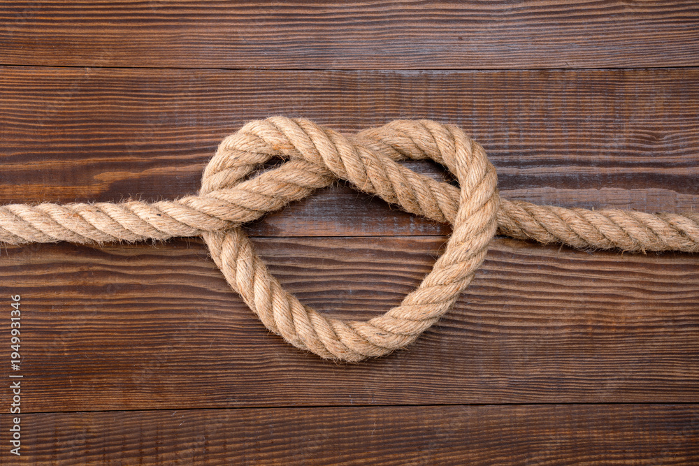 Obraz premium Thick rope on wooden background