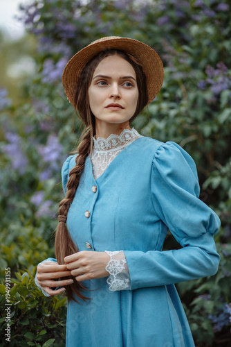 Canvastavla portrait of a young woman with a long braid, wearing a vintage period dress and a charming old-fashioned hat, surrounded by blooming lilac bushes