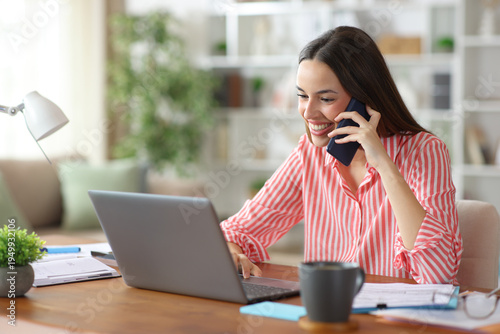 Happy self employed working attending phone call