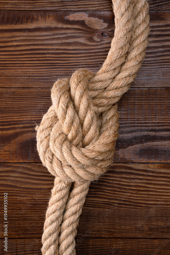 Fototapeta premium Thick rope on wooden background