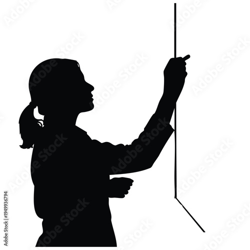 Teacher silhouette writing on blackboard with chalk during teaching