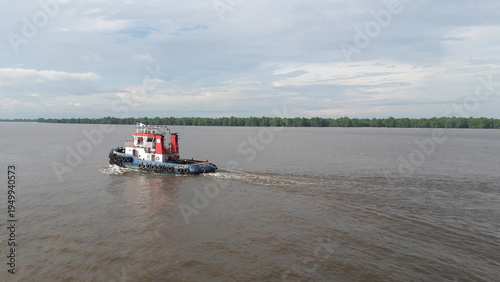 Foto Tugboat Towing on Wide River with Copy Space, Marine Transport and Logistics Con