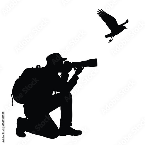 Wildlife photographer with long lens capturing bird in flight silhouette