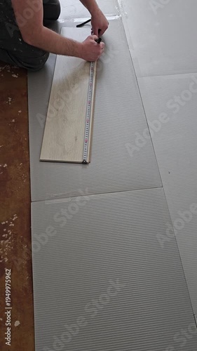 Installing vinyl flooring in a home renovation project in the living room