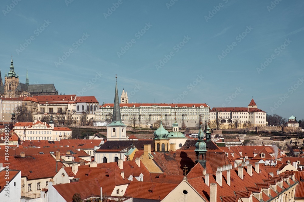 Naklejka premium Prague Castle and St Vitus Cathedral rise above red tiled roofs of Malá Strana
