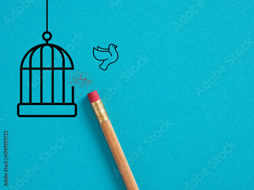 Bird escaping cage with eraser on blue background. Freedom, liberation or emancipation concepts.