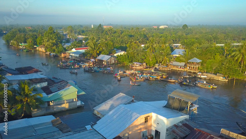 Slika na platnu AERIAL: Flying around a bustling floating market in sunny Vietnamese countryside