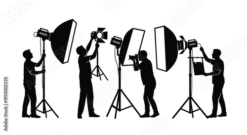 Silhouettes of professional photographers and assistants working with studio lighting equipment