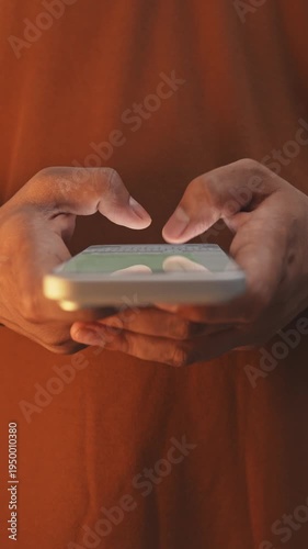 Macro close-up of a man’s hands chatting and typing on a smartphone, using the WhatsApp messaging app on social media.