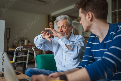 Obraz na płótnie Grandfather sharing wisdom with his grandson at home