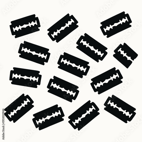 A collection of scattered black razor blades with sharp edges on a white surface