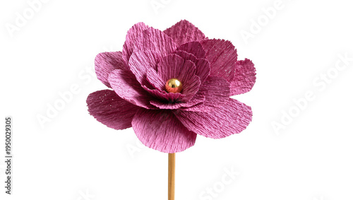 Isolated beautiful vibrant pink handmade crepe paper flower with a shimmering golden bead.