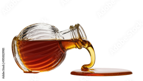Tableau sur toile Isolated glass bottle pouring viscous golden amber syrup into a sweet sticky pud