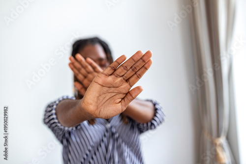 Photos Black woman making stop sign with crossed hands in front of face