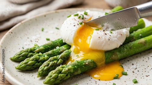 Poached Egg with Runny Yolk on Asparagus - Fresh Breakfast Delight