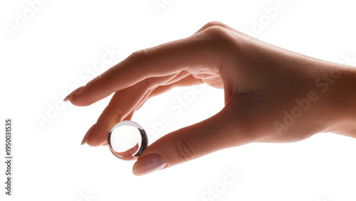 Photos Isolated female hand gently holding a clear transparent glass sphere or crystal ball