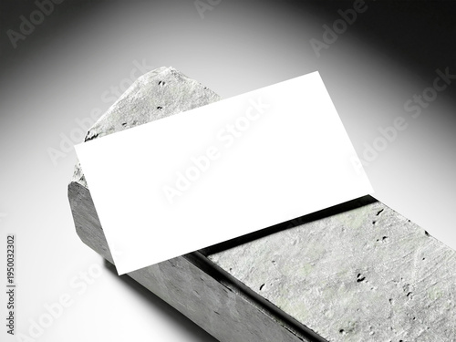 Diagonal white business card mockup resting on a rough grey concrete block.