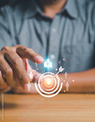 Businessmans Hand Interacting with Digital Target and People Icons, Symbolizing Business Goals and Customer Focus.