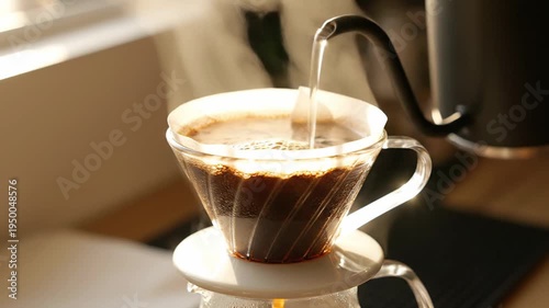 Warm and inviting scene of freshly brewed coffee being poured into a clear glass mug, highlighting the rich aroma and comforting ritual of a morning cup
