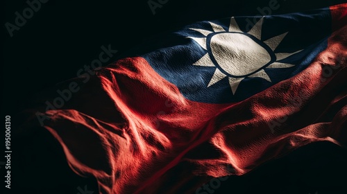 Taiwan flag waving in darkness, representing national sovereignty, patriotism, and the spirit of the republic of china, with its distinct nationalist emblem illuminated