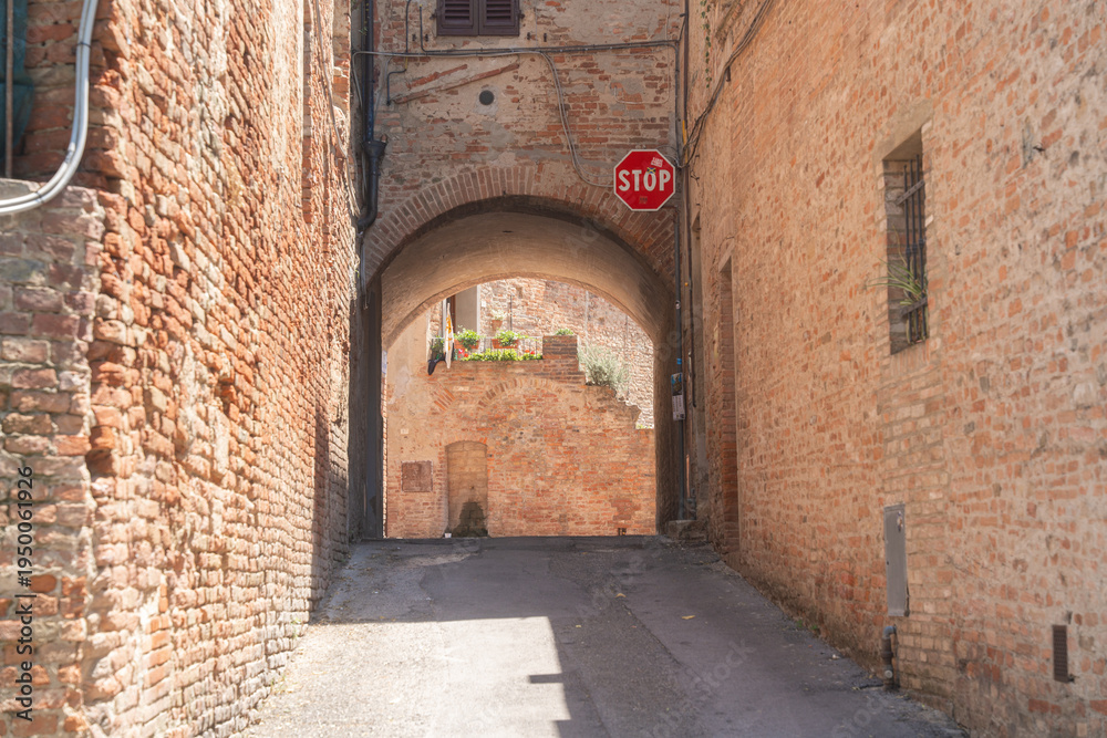 Fototapeta premium Close view of aged brick wall texture in historic european town