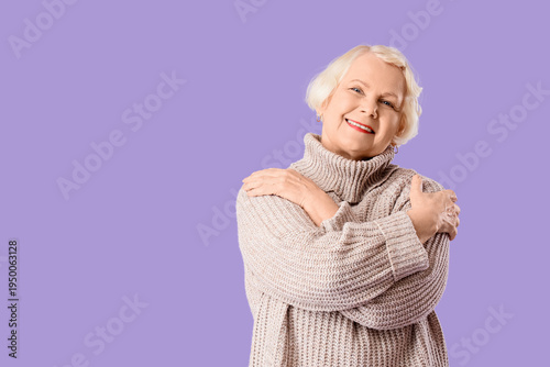 Senior woman hugging hersel...