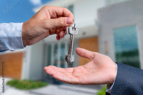 Handing over house keys during a closing ceremony in a residential area