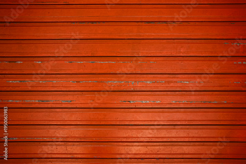 Closeup red metallic rolling door background. Metal shutter background. Steel roller shutter pattern
