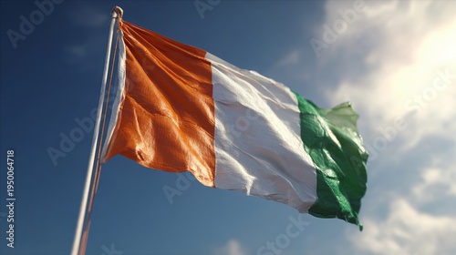 Cote d'ivoire national flag fluttering beautifully in the breeze under a clear sky, representing the country's unity, hope, and the spirit of its people