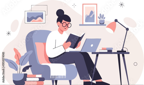 Person reading a book on an armchair with a laptop and desk nearby