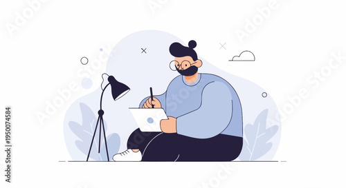 Person with glasses and beard drawing on tablet by desk lamp