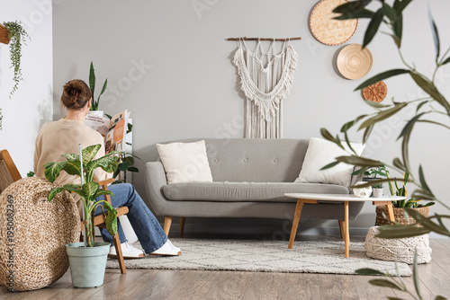 Young woman reading magazin...
