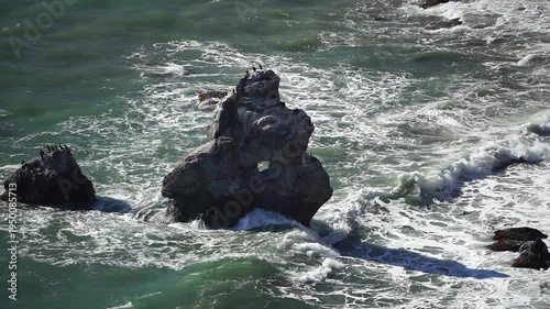 Ocean waves rocks crashing against rugged formations along a scenic coastline capturing the raw power and beauty of nature