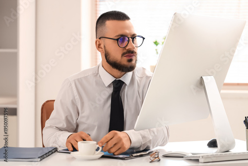 Male trader in eyeglasses w...