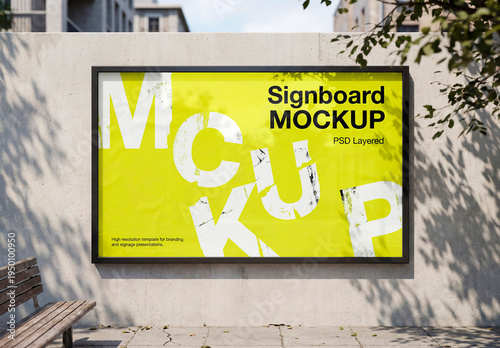 Blank horizontal poster frame mockup on concrete wall outdoors